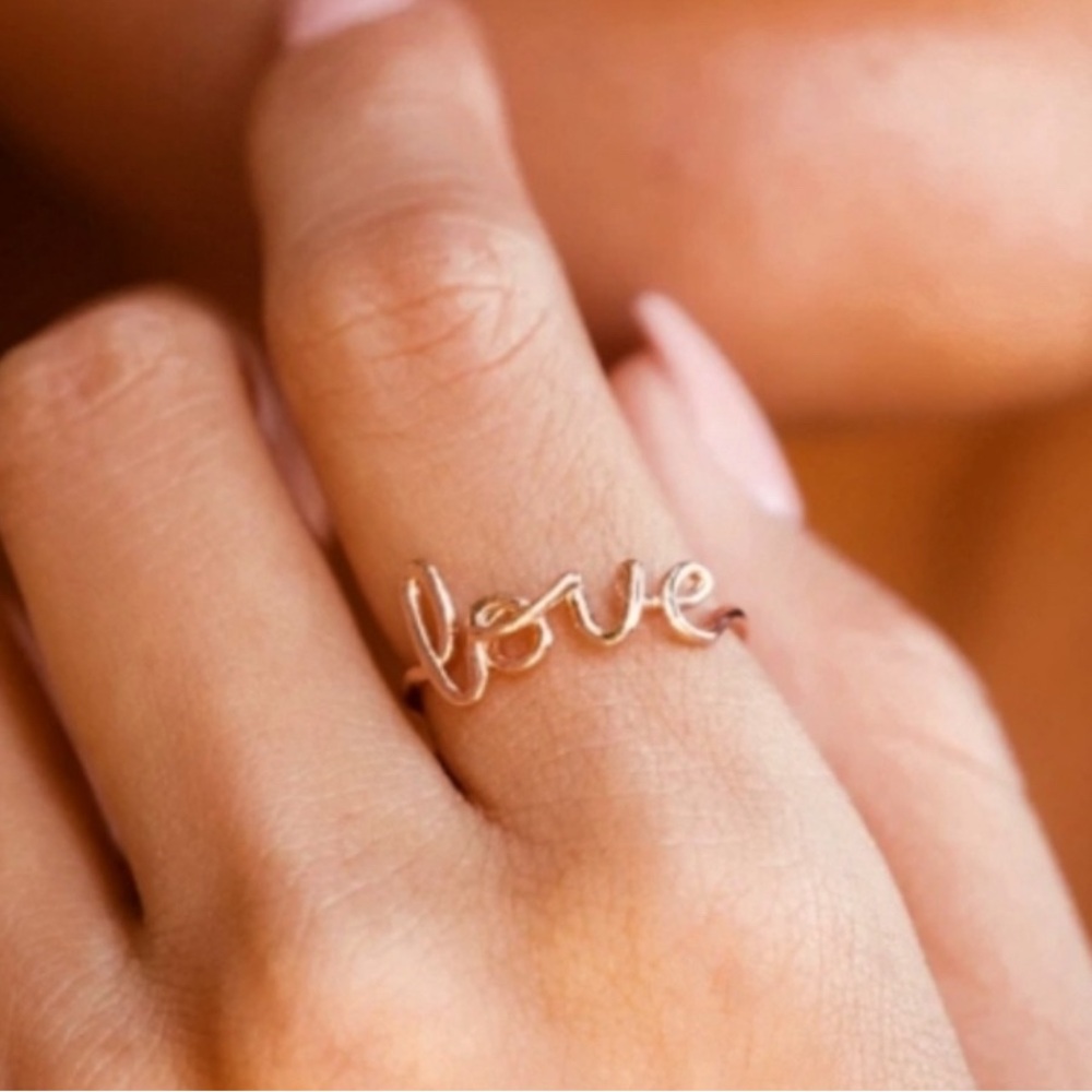 NWT Love script ring. Silver plated Copper. Size 6. Beautiful ring!